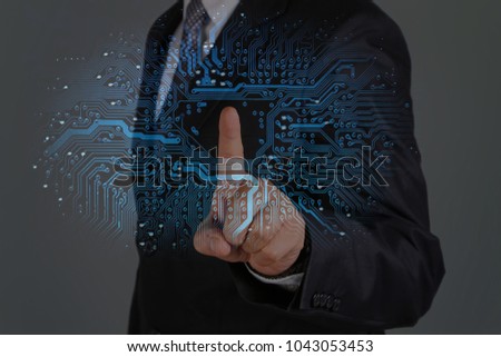 Business man touching graphic of circuit board. 