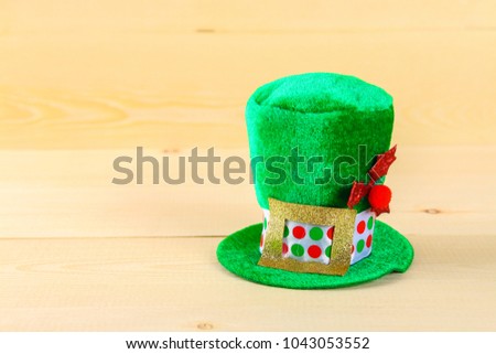 A green hat on a wooden table. St.Patrick 's Day
