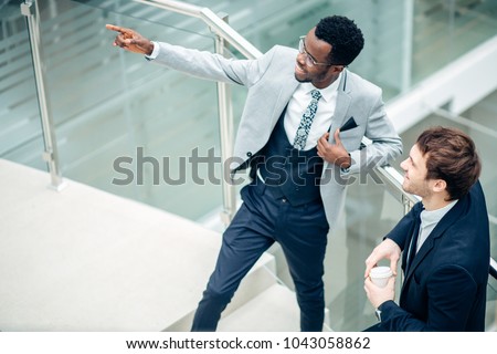 shot of afroamerican estate agent with potential client inside an empty office space