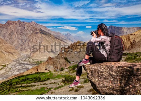 Dhankar gompa. Spiti Valley, Himachal Pradesh, India. Nature photographer tourist with camera shoots while standing on top of the mountain.