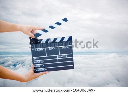 Man hands holding movie clapper.Film director concept.camera show viewfinder image catch motion in interview or broadcast wedding ceremony, catch feeling, woman hand hold a Film Slate with sky.