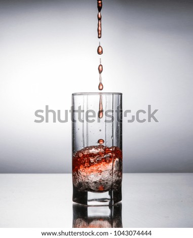 beautiful glass with spatter of alcoholic beverage