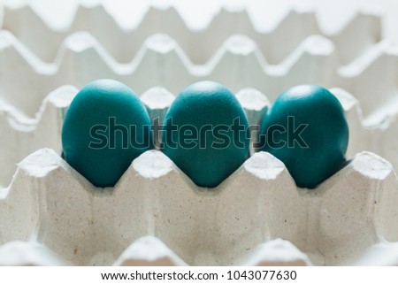Easter eggs of different colors in tray