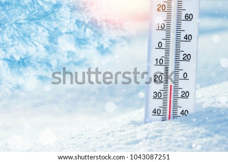 Wintertime. Winter background with  thermometer in the snow on frosty day.