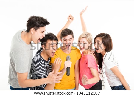 Group of happy friends singing song together
