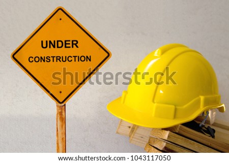 protecting by helmet  in under contruction building site with safety first concept