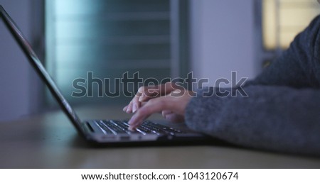 Woman working on laptop computer at night 