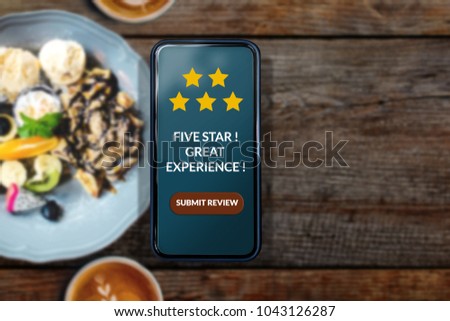 Customer Experience Concept. Enjoying Food and Drink. Woman using Smartphone in Cafe or Restaurant to Feedback Five Star Rating in Online Satisfaction Survey Application, Food Review, Top View Royalty-Free Stock Photo #1043126287