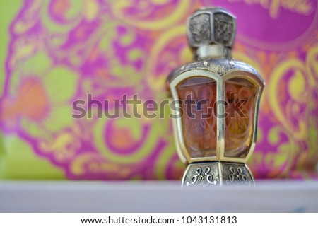 Picture of Arabian perfume in pink and green background