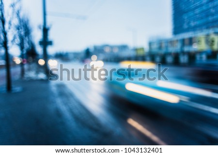 blurred abstract background image of cars passing the street at the rush hour. blurred taxi car