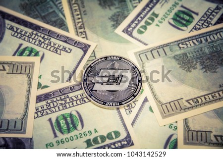 Dash coin crypto currebcy on US dollars. Digital currency close-up. Virtual money. Metal coins of Dash coin on banknotes of one hundred dollars. Exchange. Bussiness, commercial.