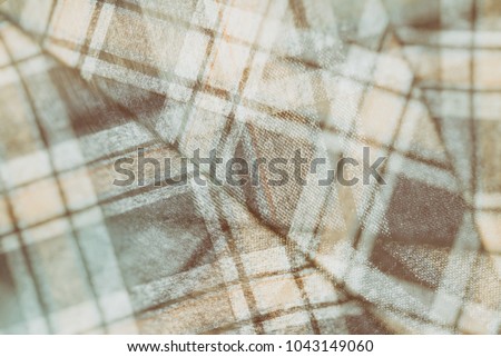 Flannel, cotton into the classic scottish cell as textile background in vintage style,  double exposure photo 
