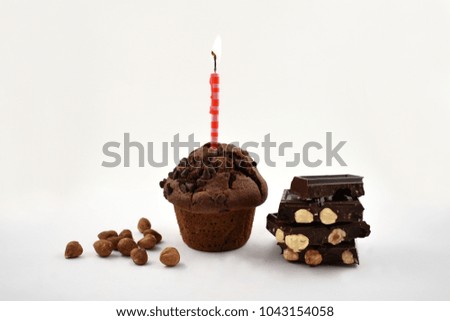 Muffin with chocolate and nuts stock images. Chocolate muffin and nuts on a white background. Sweet party pastry. Birthday concept