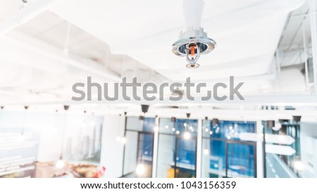 Fire Sprinkler in office building blur background., focus at selective Royalty-Free Stock Photo #1043156359