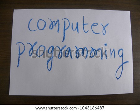 Text computer programming hand written by blue oil pastel on white color paper