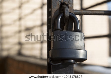 old lock on a lattice brick background under sun