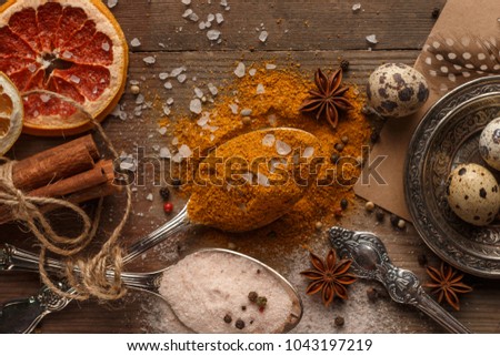 Spices and dried fruits on a rustic table.