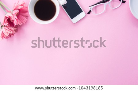Flat lay of modern pink office desk with smartphone and other supplies, minimal style, copy space.
