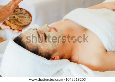 asian woman having face treatment in spa salon on the bed, beauty facial mask Royalty-Free Stock Photo #1043219203