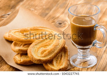cup of coffee and cookies on a wooden table