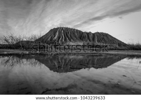Ash mountain and its reflection on a artificial lake in Rummu, Estonia