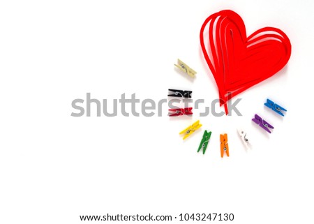 Red heart in the middle of color paper clips on white background ,Valentine's Day background.