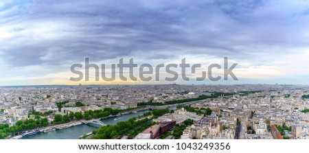 Panoramic image of Beautiful cityscape of Paris from The Eiffel Tower viewing Basilica of the Sacred Heart of Paris in distance in twilight ,  France