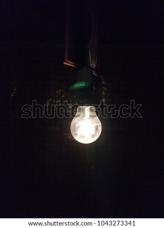 Illuminated light bulb in dark