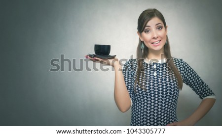 Coffee break. Coffee time. Lunch break. Happy smiling woman holding in hands a cup of coffee isolated on gray background with copy space.