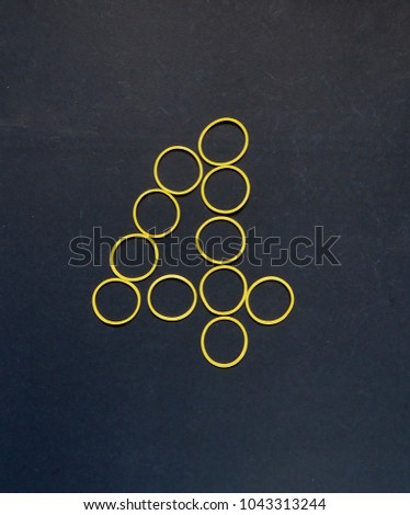 Arabic numerals four, yellow color isolated on dark background
