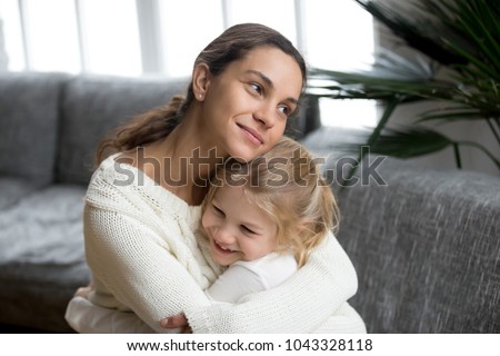 Loving single mother hugging cute little daughter showing love care support, happy woman embracing preschool girl at home, mum and kid sincere warm relationships, new mom for adopted child concept Royalty-Free Stock Photo #1043328118