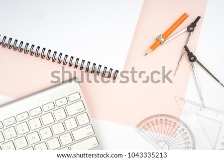 Creative arrangement of geometry stationery like protractor, metal compass on pastel paper. Education in mathematics, architecture and engineering concept. Flat lay.Copy space for text on notepad page