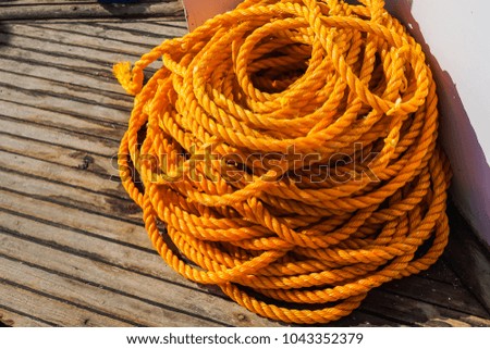 Yellow rope in piles on the market. Braided rope for sailing ship, house works, construction. Rope bunch image. Horizontal image for housework, reconstruction, DIY project, hand tool. Gardening supply