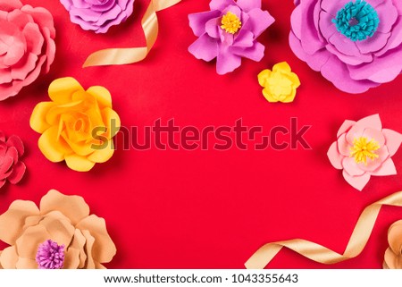 Beautiful floral spring or summer background. Papercraft flowers on red, top view, flat lay, copyspace