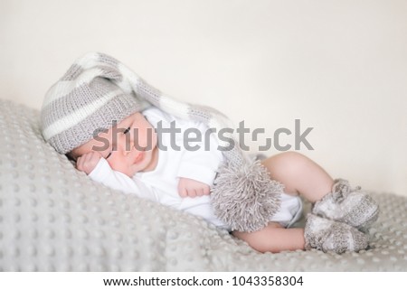 A newborn infant, the baby is sleeping lying on his stomach on a soft blanket