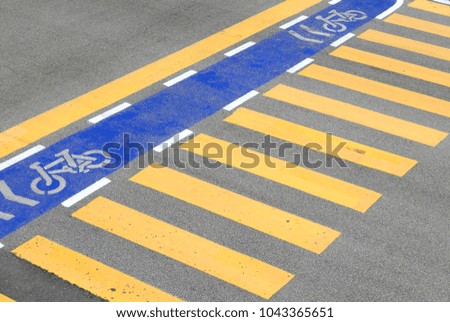 Yellow zebra crossing or pedestrian crossing and blue lane of for bicycle.