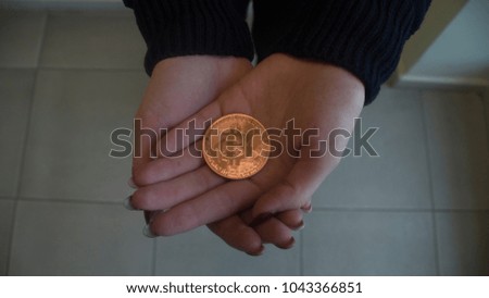 bitcoin lying on his hands