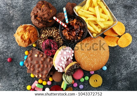 Unhealthy products. food bad for figure, skin, heart and teeth. Assortment of fast carbohydrates food.  Royalty-Free Stock Photo #1043372752