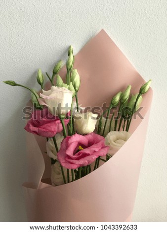 Spring bouquet of Eustoma, white and pink tulips on a white background. Congratulations on the 8th of March.