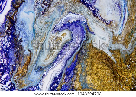 Beautiful abstract background. Golden and dark blue mixed acrylic paints. Marble texture. Contemporary art.