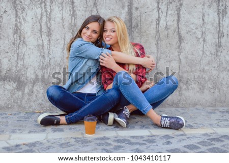 Leisure funtime shoes sneakers takeaway to go mug tea shop feelings face emotion expressing concept. Portrait of nice glad beautiful pretty cute cool adorable hugging girls isolated on gray background