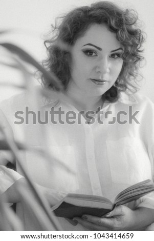 Plus size woman in shirt read book, monochrome photo with grain. vintage picture