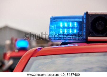 fire fighter trucks with blue flashing lights Royalty-Free Stock Photo #1043437480