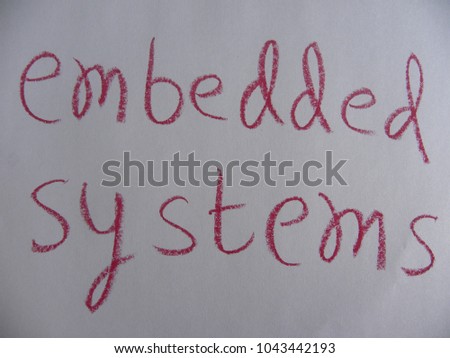 Text embedded systems hand written by red oil pastel on white color paper