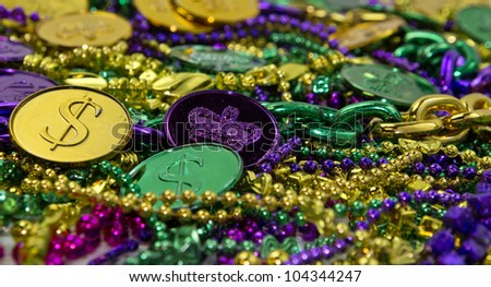 Colorful Mardi Gras beads & coin background