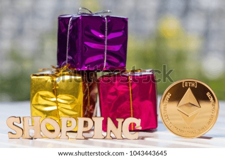 Eretheum coin crypto currency with golden colored gift box and 'SHOPPING' text on wooden table top