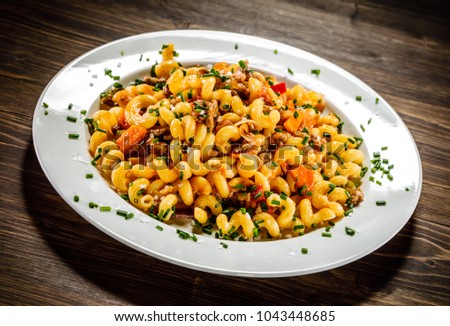 Pasta with meat, tomato sauce and vegetables
 Royalty-Free Stock Photo #1043448685
