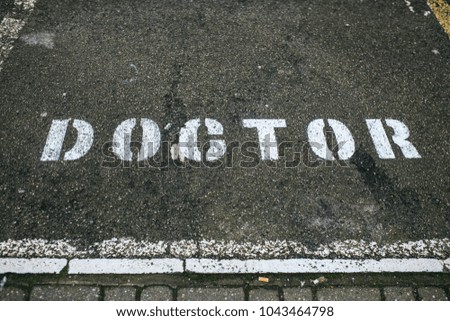 white doctor sign painted in a road