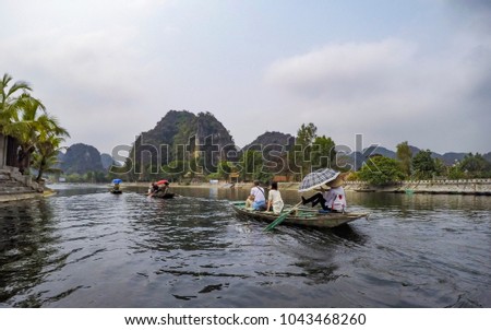 Tourists on a boat trip at Tam Coc, Binh Ninh - Vietnam - Asia