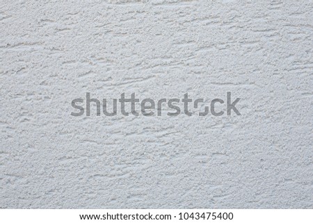 Facade plaster background. Single-ply monolithic plaster decorative background. Single layer scraped cement plaster wallpaper. Exterior building structure backdrop. Silica  sand cement wall plaster.